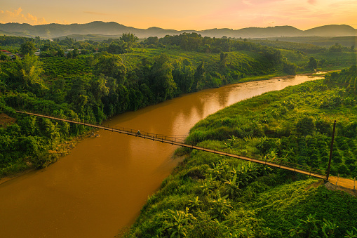 Drone view of of cable-stayed suspension bridge in sun set, Kon Tum province