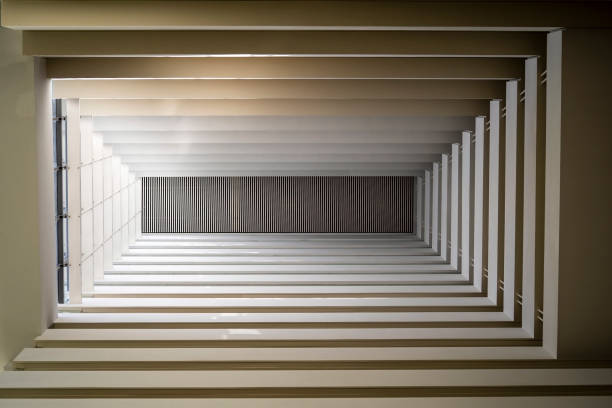 Building interior with balconies and geometric shapes in the background. Modern apartment building. Lines patterns of building, architecture design concept
