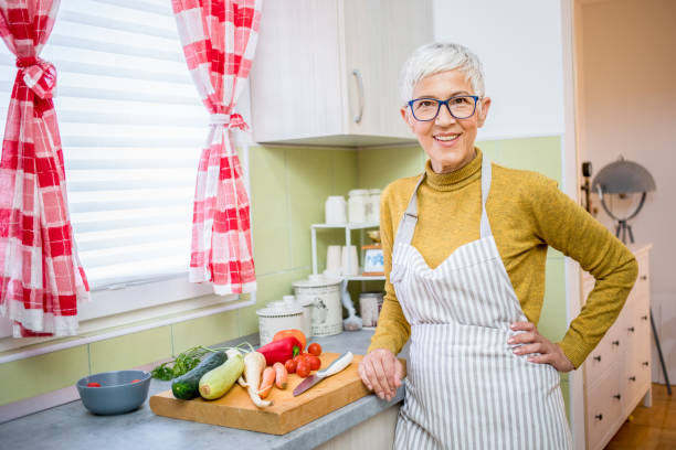 istock Senior woman cooking. 1281832739
