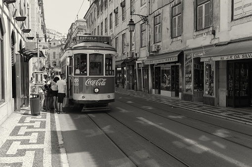 Lisbon, Portugal - August 21, 2013: Passangers board a traditional tram in Lisbon downtown.