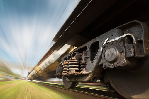 Freight train on the railroad. Industrial landscape of a freight train traveling on a railroad with blurred background.