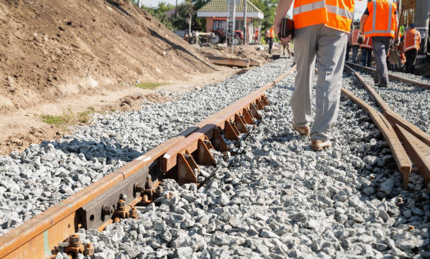 istock Railway repair. Uniformed workers are changing the old railway line. 1281834984