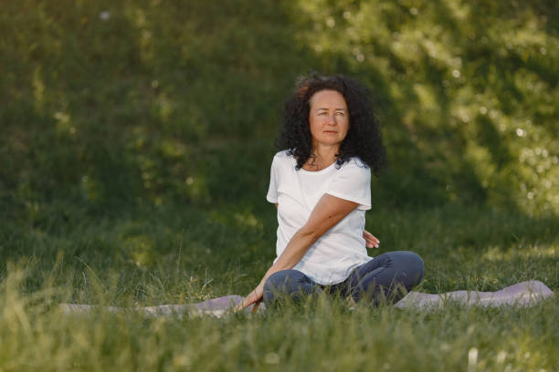 istock Old woman practicing advanced yoga in a summer park 1281835282
