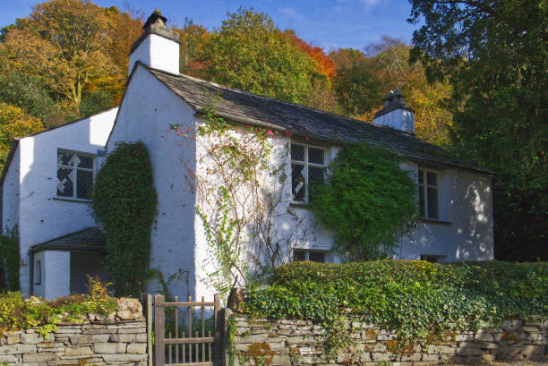 Autumn at Dove Cottage the home of the poet William Wordsworth in Grasmere in the English Lake District, Cumbria, UK. Dove Cottage surrounded by autumn colors. It was the home of the English Victorian poet William Wordsworth from 1799 to 1808 in Grasmere village near Ambleside in the English Lake District, Cumbria, UK. grasmere stock pictures, royalty-free photos & images
