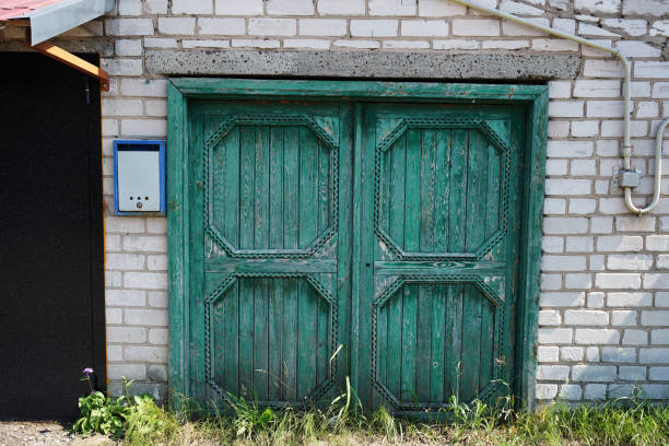 istock carved green gate in a brick wall. High quality photo 1281836327