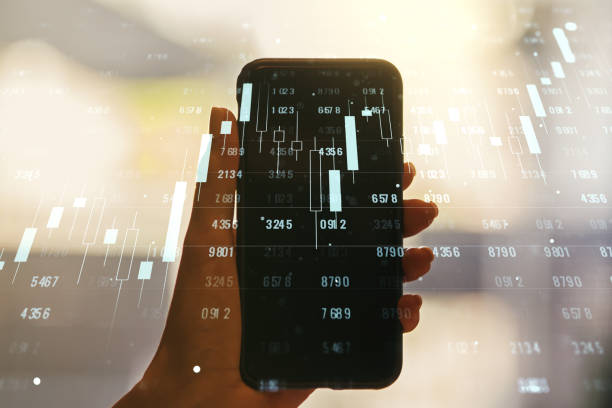 istock Abstract creative stats data concept and hand with phone on background. Multiexposure 1281836665