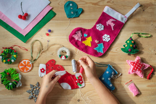 istock Christmas crafting, hands holding needle and sewing felt heart 1281837026