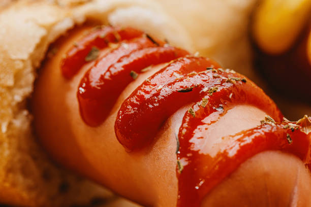 classic American hot dog with mustard and ketchup close-up