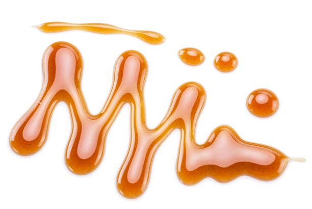 istock Sugar caramel sauce curls isolated on white background. Top view. 1281839665