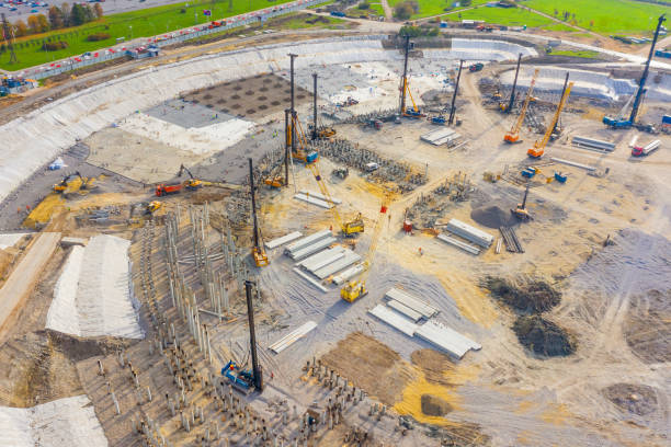 istock Equipment for installing piles in ground, heavy machines for driving pillars work in laying the foundation building. Construction aerial view height. 1281841125