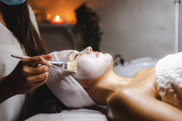 You can never have too many facials Shot of a young woman getting a facial treatment at a spa never stock pictures, royalty-free photos & images