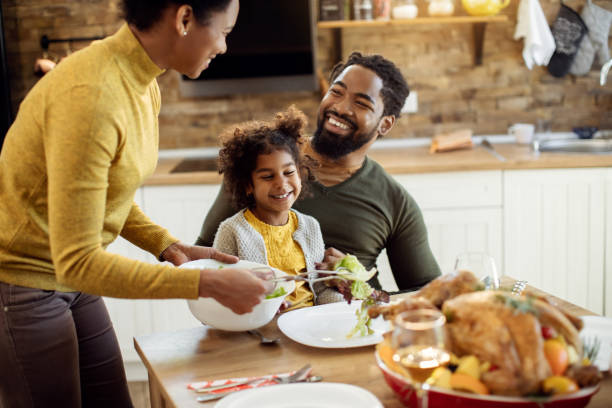 istock Happy black family having Thanksgiving lunch at dining table. 1281845425