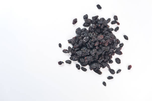 black raisin on white background, close up