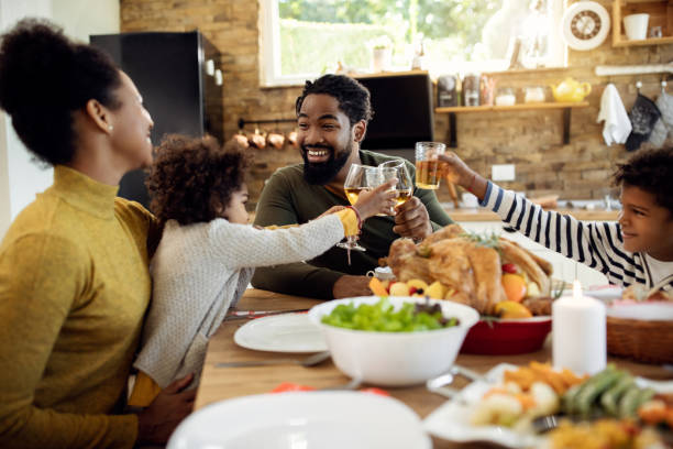 istock Happy black family toasting during Thanksgiving lunch at dining table. 1281845871