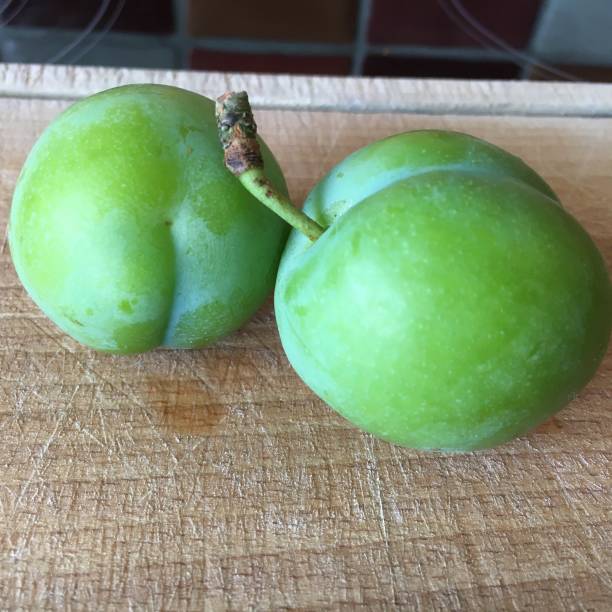 istock Green gage plum on a wooden chopping board 1281856272