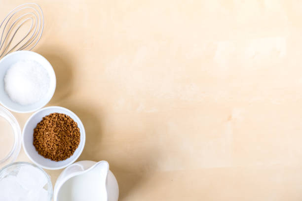 istock How to make coffee dalgona. Step by step photo instruction. Step 1 Preparation. Ingredients - instant coffee, sugar, water, milk and a whisk for whipping on a wooden background. Top view. copy space 1281857627