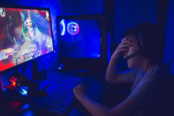 istock Emotional kid play computer games online 1281857827