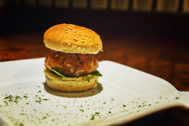 istock Mini hamburger in bar food skewer on wooden table 1281858526