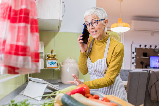 istock Senior woman cooking. 1281858686