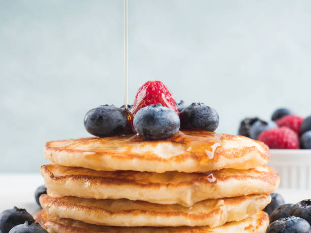 istock Stack of pancakes with blueberries and syrup 1281859084
