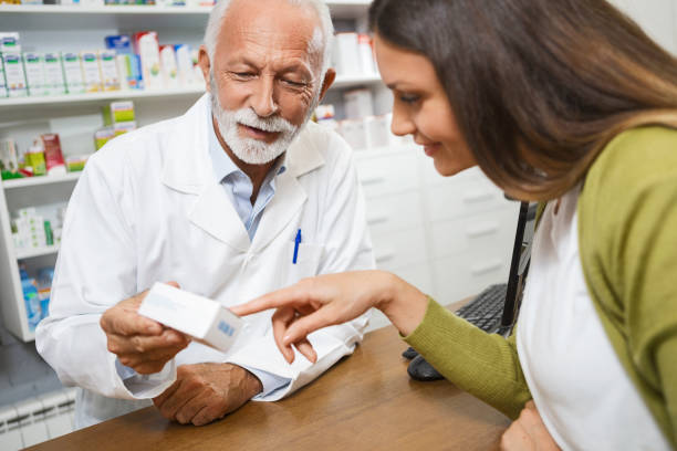 istock Senior pharmacist giving medications to a customer 1281859963