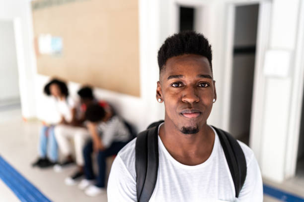 Portrait of a student in the university corridor Portrait of a student in the university corridor serious black teen stock pictures, royalty-free photos & images