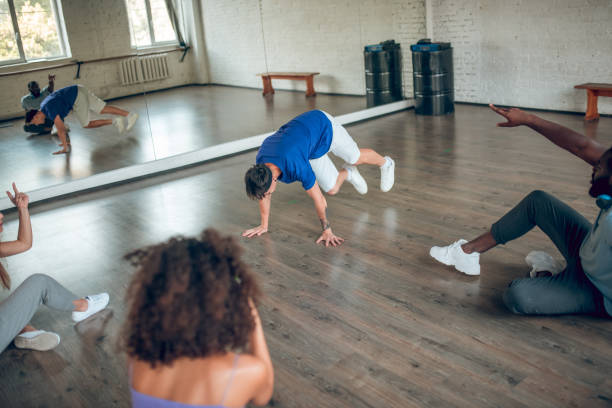 istock Teacher showing a handstand to his students 1281862588