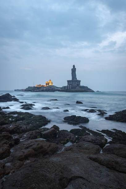 Dawn view of the sea from sea shore with statue Dawn view of the sea from sea shore with statue image is showing Vivekananda rock memorial and Thiruvalluvar statue at kanyakumari india. Image taken in Dawn from low angle with long exposure. tamil nadu landscape stock pictures, royalty-free photos & images