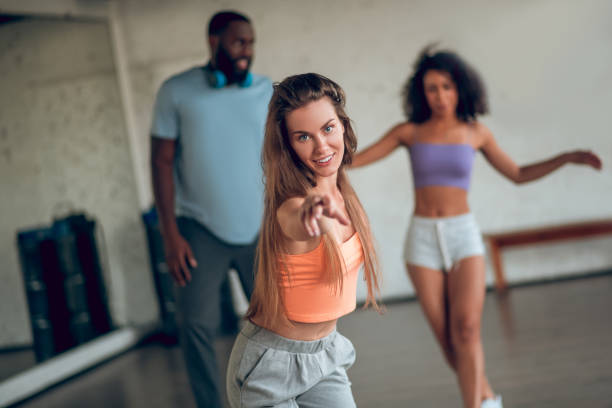 istock Confident young woman teaching students to dance 1281862721