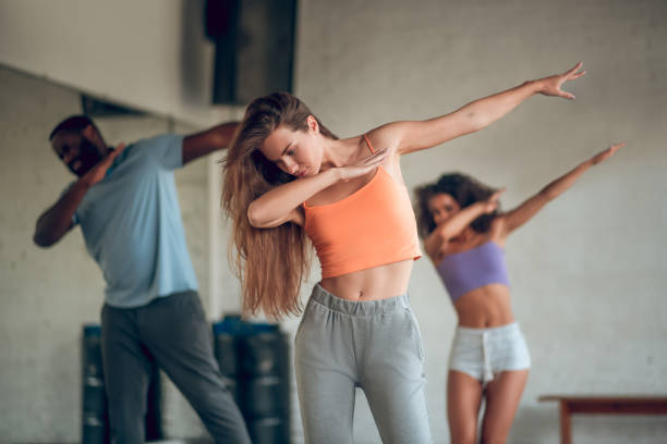 istock Group of people dancing synchronized choreography together 1281862726