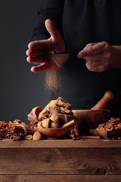 istock The cook sprinkles the chocolates with cocoa powder. 1281863727