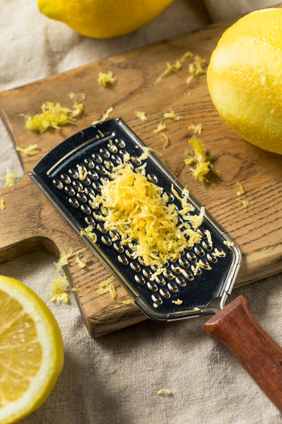 сырая желтая органическая лимонная цедра - grater grated peel ingredient стоковые фото и изображения