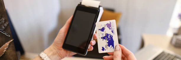 istock Close up female hands holding credit card reader 1281867920