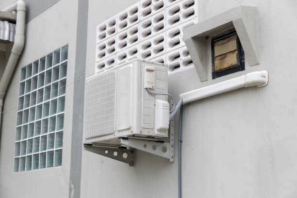 istock Air conditioner compressor installed in old building. Outdoor split wall type air conditioner compressor unit inverter installed on the outside of the building. Air conditioner compressor outdoor unit 1281868972