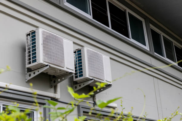 istock Air conditioner compressor installed in old building. Outdoor split wall type air conditioner compressor unit inverter installed on the outside of the building. Air conditioner compressor outdoor unit 1281868976