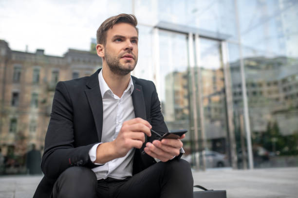 istock A businessman writing a message on a smartphone and looking thoughtful 1281870220