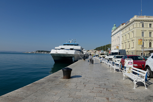 Riva promenade is the most popular and most important public place in Split. Sailboat and benches.