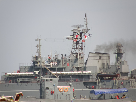 Algiers, Algeria - September 16, 2022: Algerian Naval Forces Site. Lifeboat and unrecognizable persons on it, number 472 written on it. Shot at golden hour sunrise.