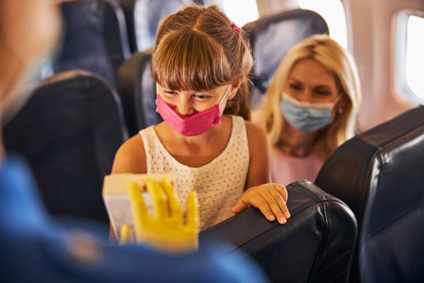 istock Child in a medical mask looking at a chocolate package 1281875372