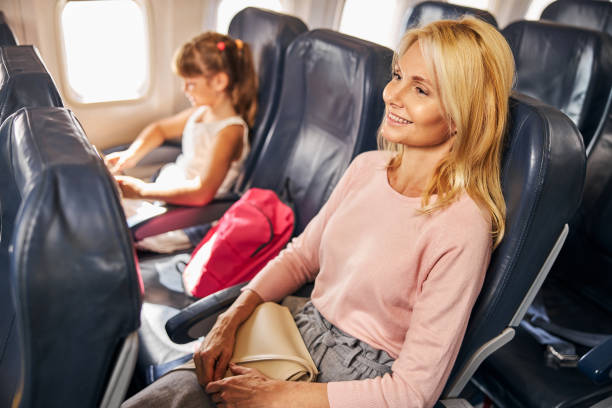 istock Relaxed mother resting on a plane seat 1281875408
