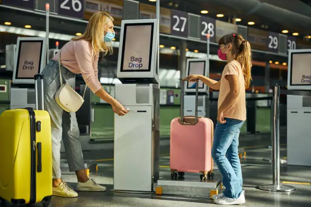 Photo of Daughter and mother getting suitcase weight results