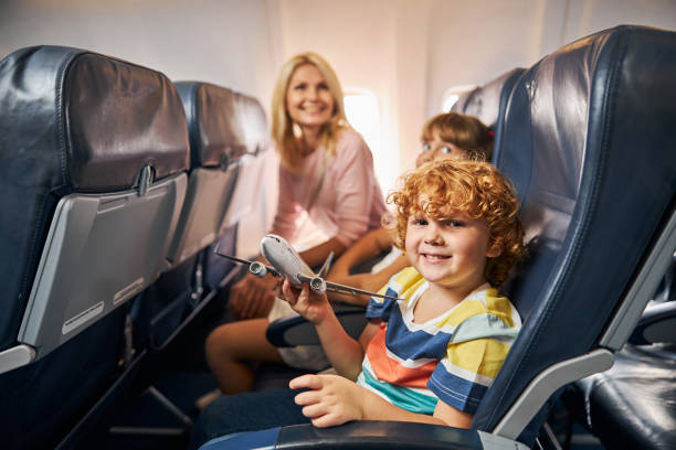istock Cheerful child playing with a toy airplane 1281875482