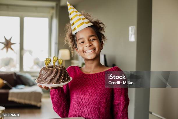 Portrait Of African American Girl With Birthday Cake At Home Stock Photo - Download Image Now
