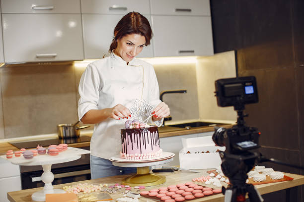 istock Confectioner in a uniform decorates the cake 1281878006