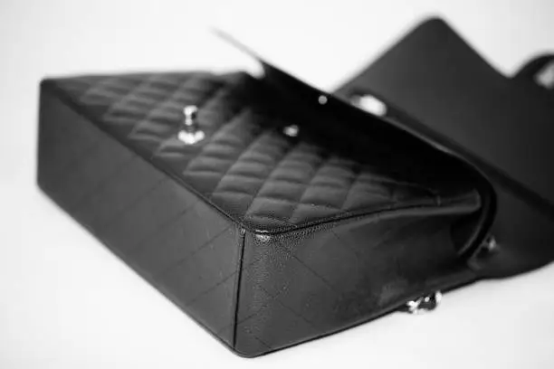 Photo of Classic black handbag on white background