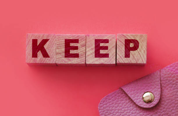 istock Keep word on wooden blocks and leather wallet. Saving things as they are. Save money concept 1281879049