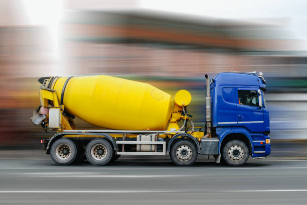 istock Blue and Yellow cement mixer truck in motion 1281879791