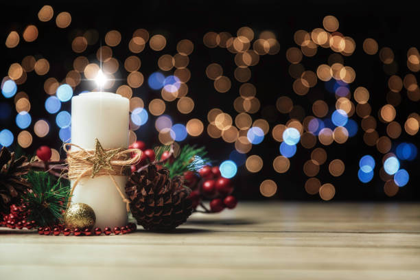 christmas candle lights on rustic wooden table and copy space. christmas themes. - themes imagens e fotografias de stock