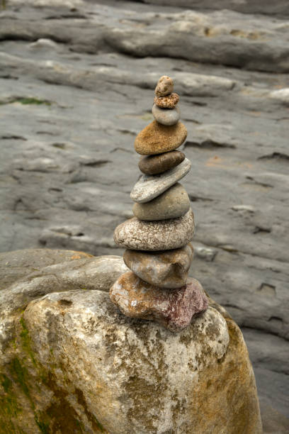 istock Rock cairn on log , beach of Cantabria, Spain 1281880746