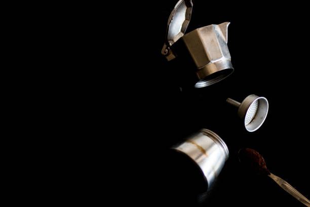 Ingredients for making moka coffee. Moka pot with coffee on dark background. Coffee making concept.